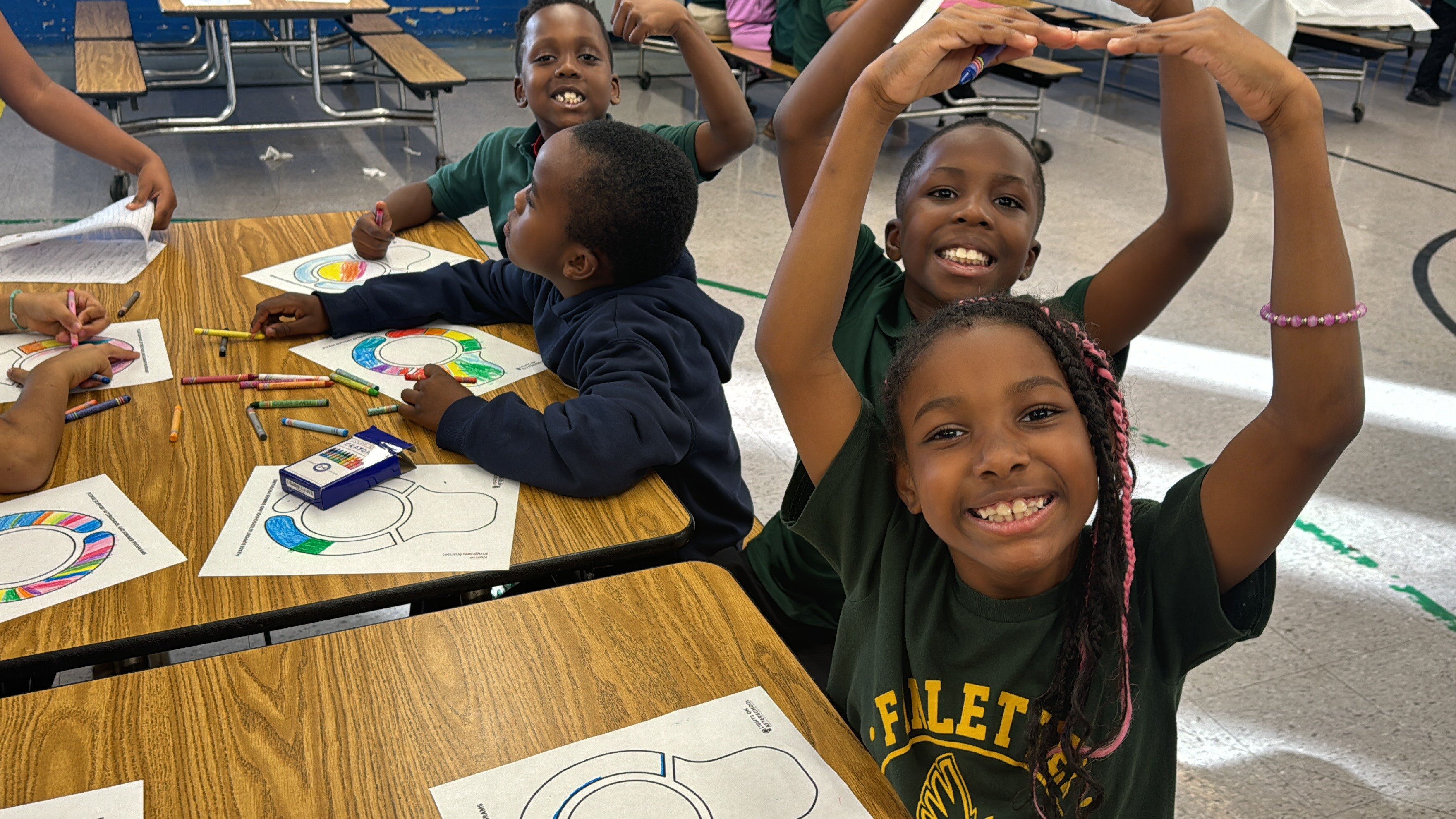 Children making a lightbulb shape with their arms above their heads